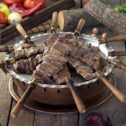 Authentic Oltu Cağ Kebabı served on skewers with lavash and onion salad